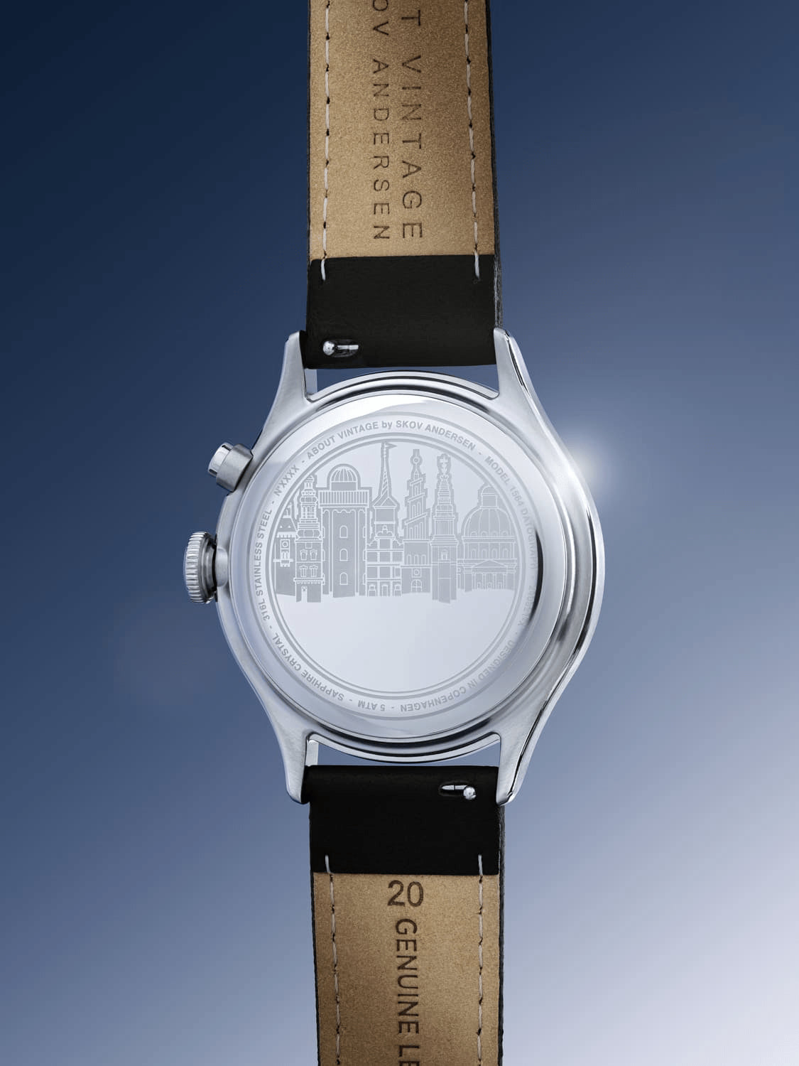 1564 Chronodate Automatic by AV86 showing polished stainless steel case back with cityscape engraving and black leather strap