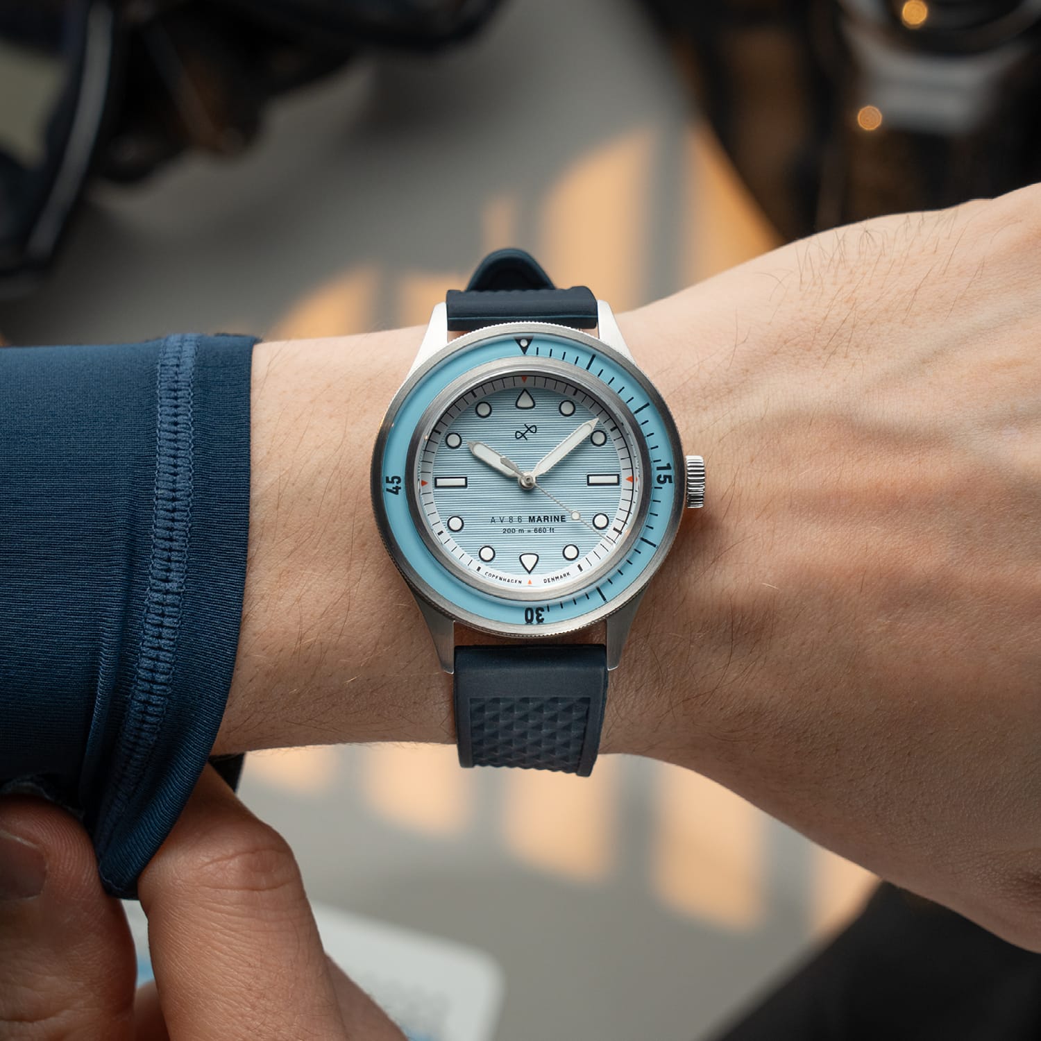 1956 Marine by AV86 vintage-inspired diver with compass bezel, sapphire crystal, and textured rubber strap on wrist