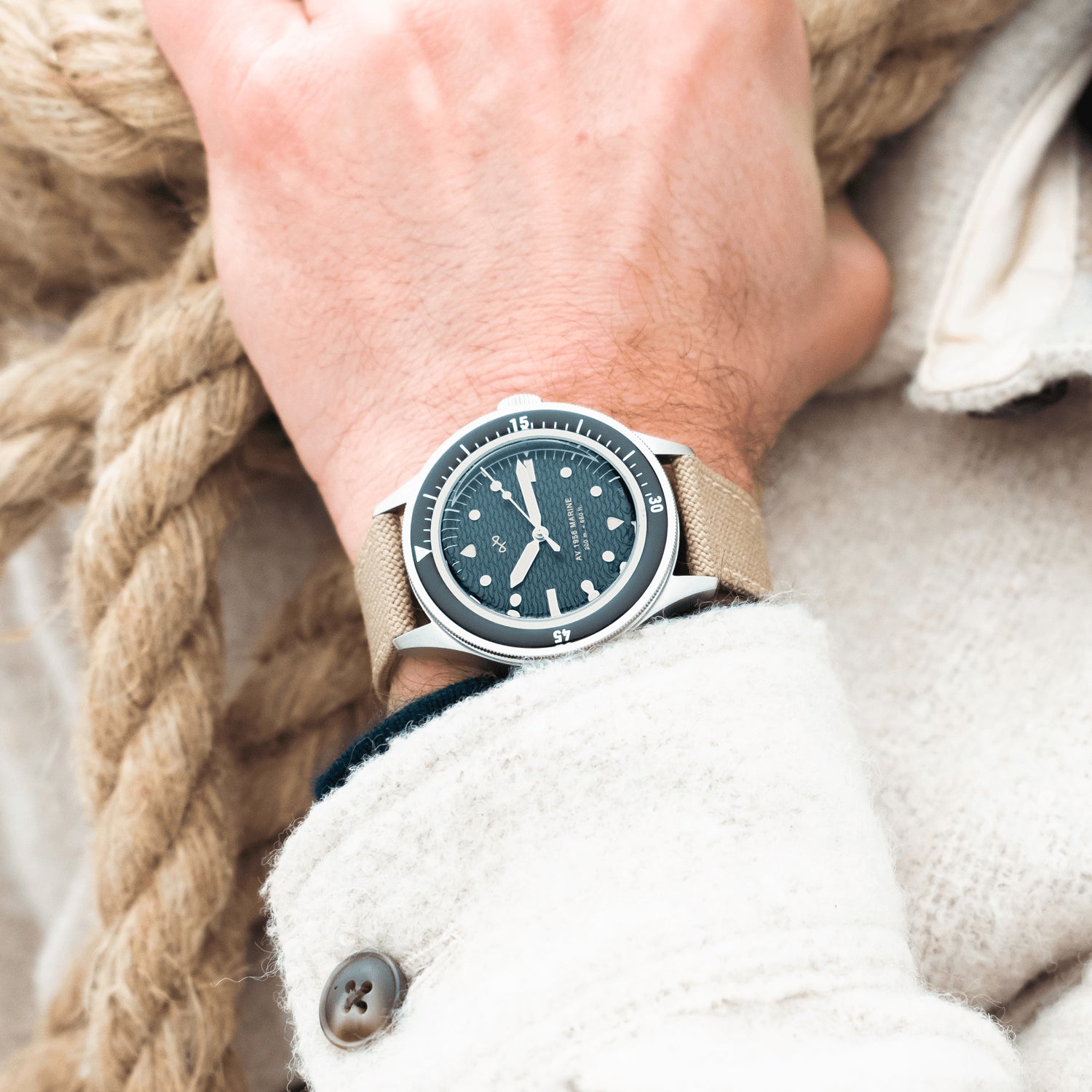 1956 Marine by AV86 vintage-inspired diver with acrylic bezel, luminous markers, and beige fabric strap on wrist