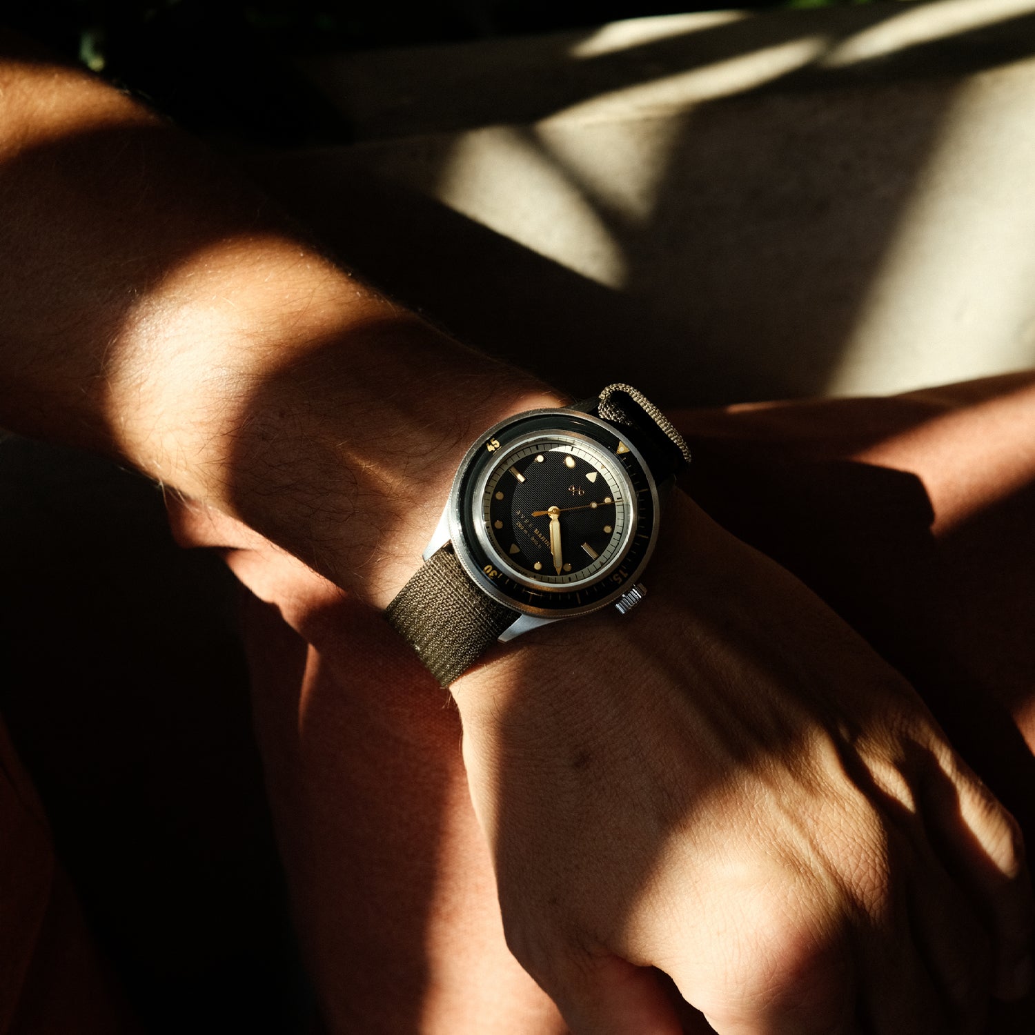 AV86 vintage-inspired diver with sapphire crystal, compass bezel, and textured fabric strap worn in natural sunlight with Nordic minimalism vibe