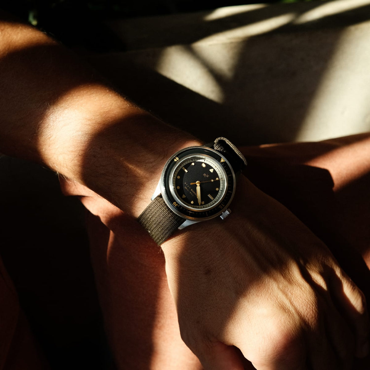 AV86 vintage-inspired diver with sapphire crystal, compass bezel, and textured fabric strap worn in natural sunlight with Nordic minimalism vibe