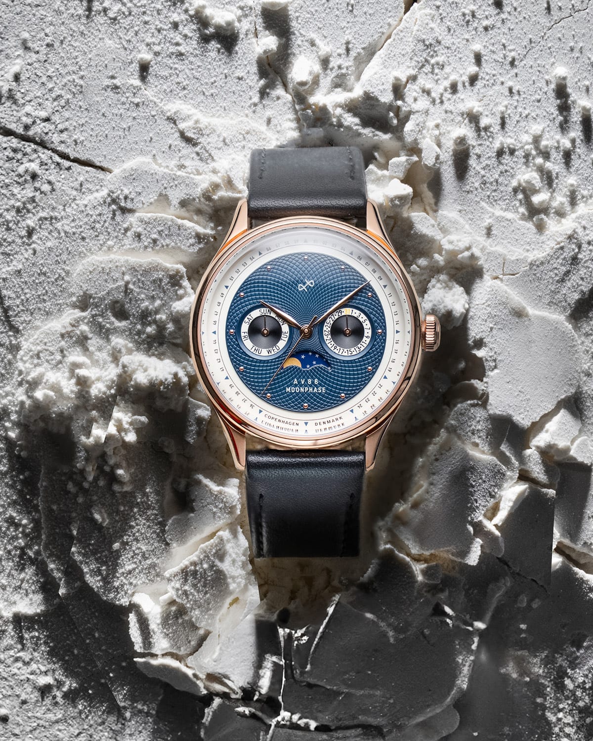 VB Kong Hans Eg by AV86 elegant moonphase watch with textured dial, dual subdials, sapphire crystal, and leather strap on textured surface