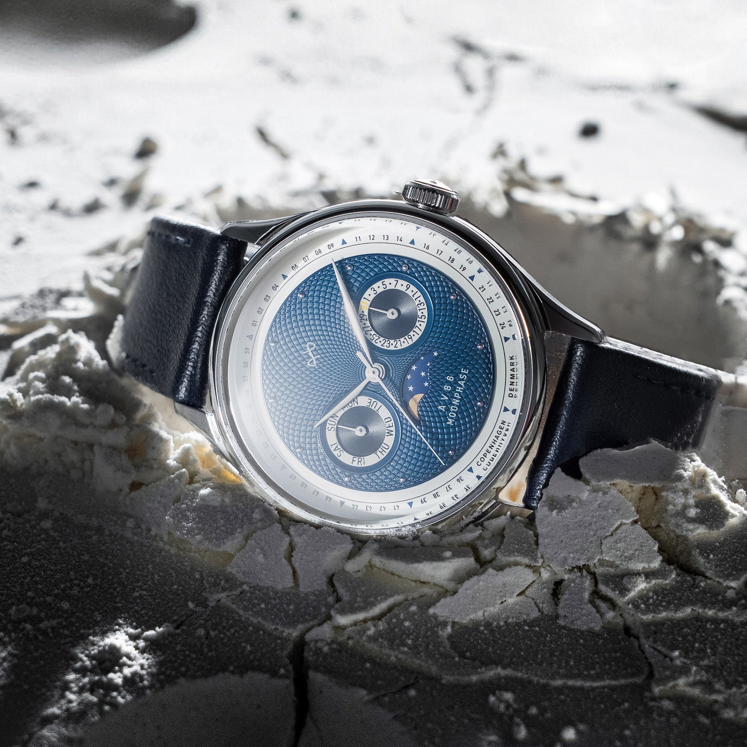1968 Moonphase by AV86 luxury Moonphase watch with sapphire crystal, textured dial, and black leather strap in artistic setting