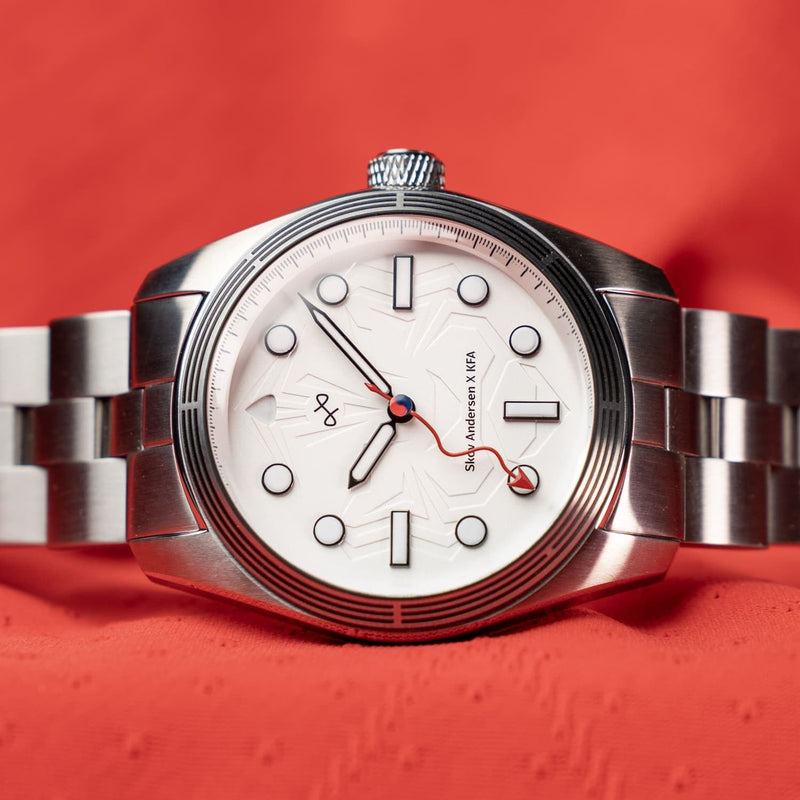 Play-on KFA x Skov Andersen by AV86 with embossed tiger dial, sapphire crystal, steel case, and brushed metal bracelet in minimalist design
