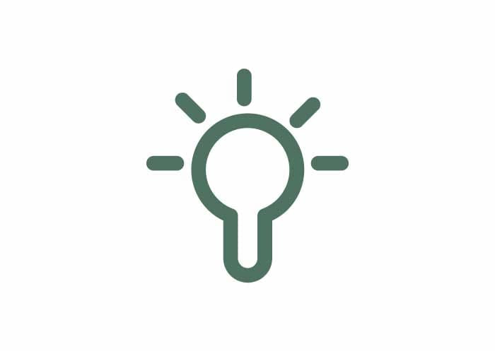 Green light bulb outline icon with six rays on a plain white background