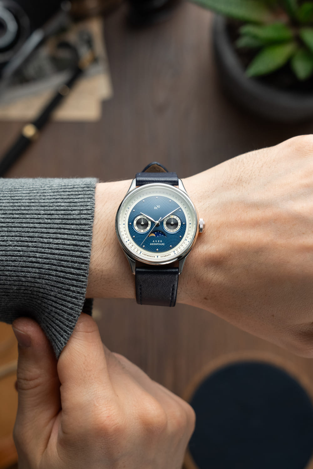 1968 Moonphase by AV86 vintage-inspired moonphase watch with sapphire crystal, moonphase dial, and dark leather strap on wrist