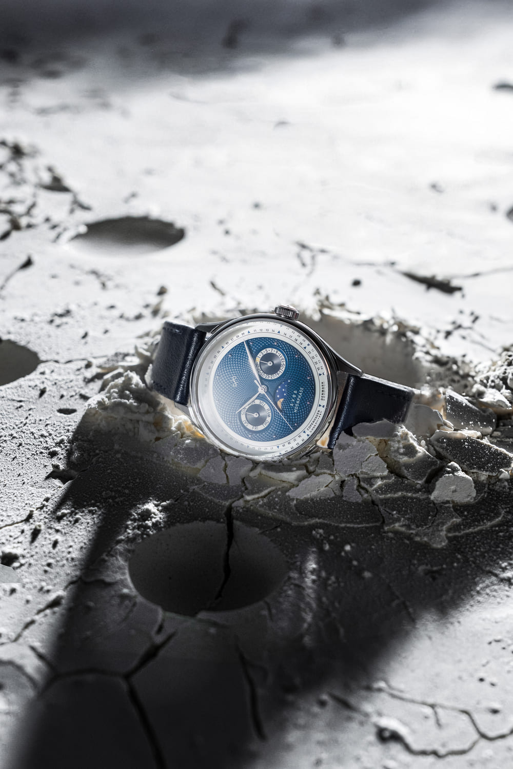 1968 Moonphase by AV86 luxury moonphase watch with sapphire crystal, textured dial, and dark leather strap on lunar surface setting