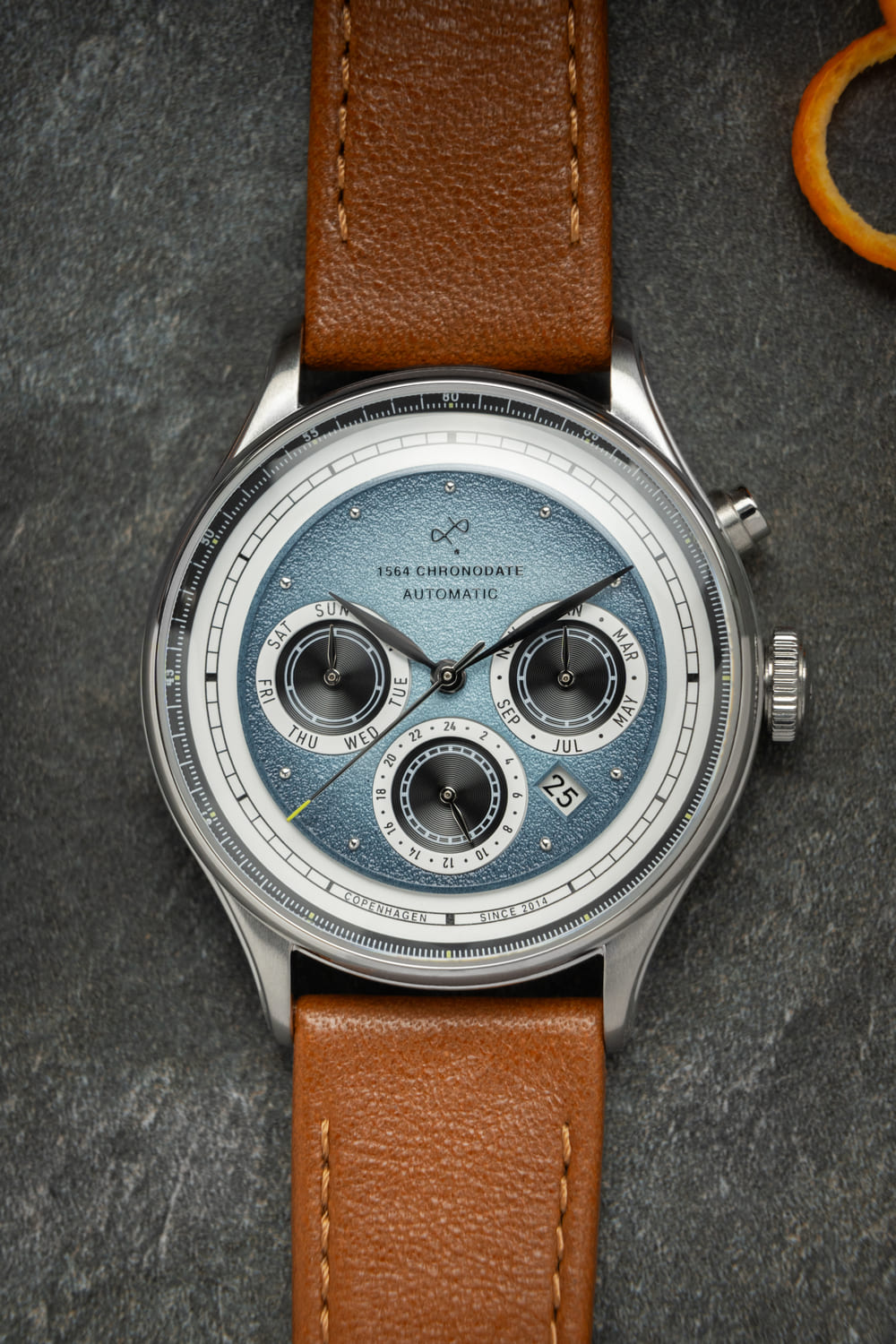 1564 Chronodate Automatic by AV86 vintage-inspired chronograph with sapphire crystal, textured dial, and brown leather strap
