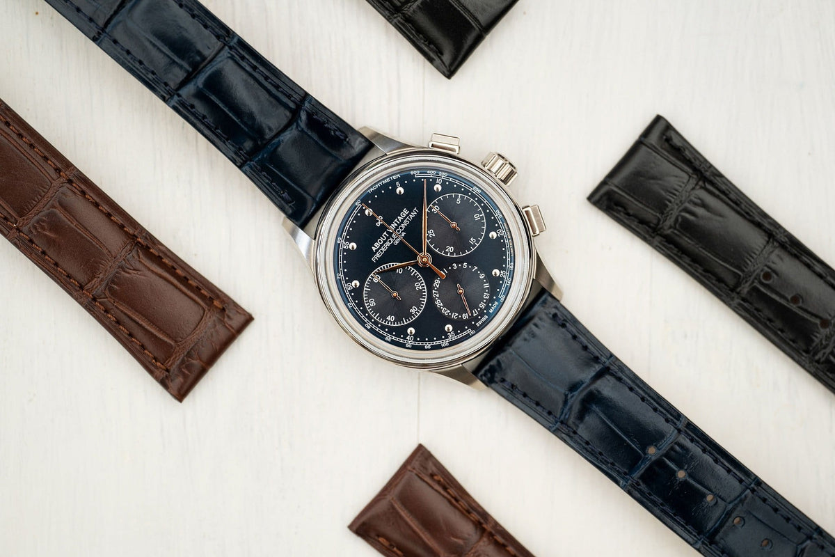AV86 chronograph with textured dark dial, three subdials, polished case, fine markers, and crocodile texture leather strap among spare straps