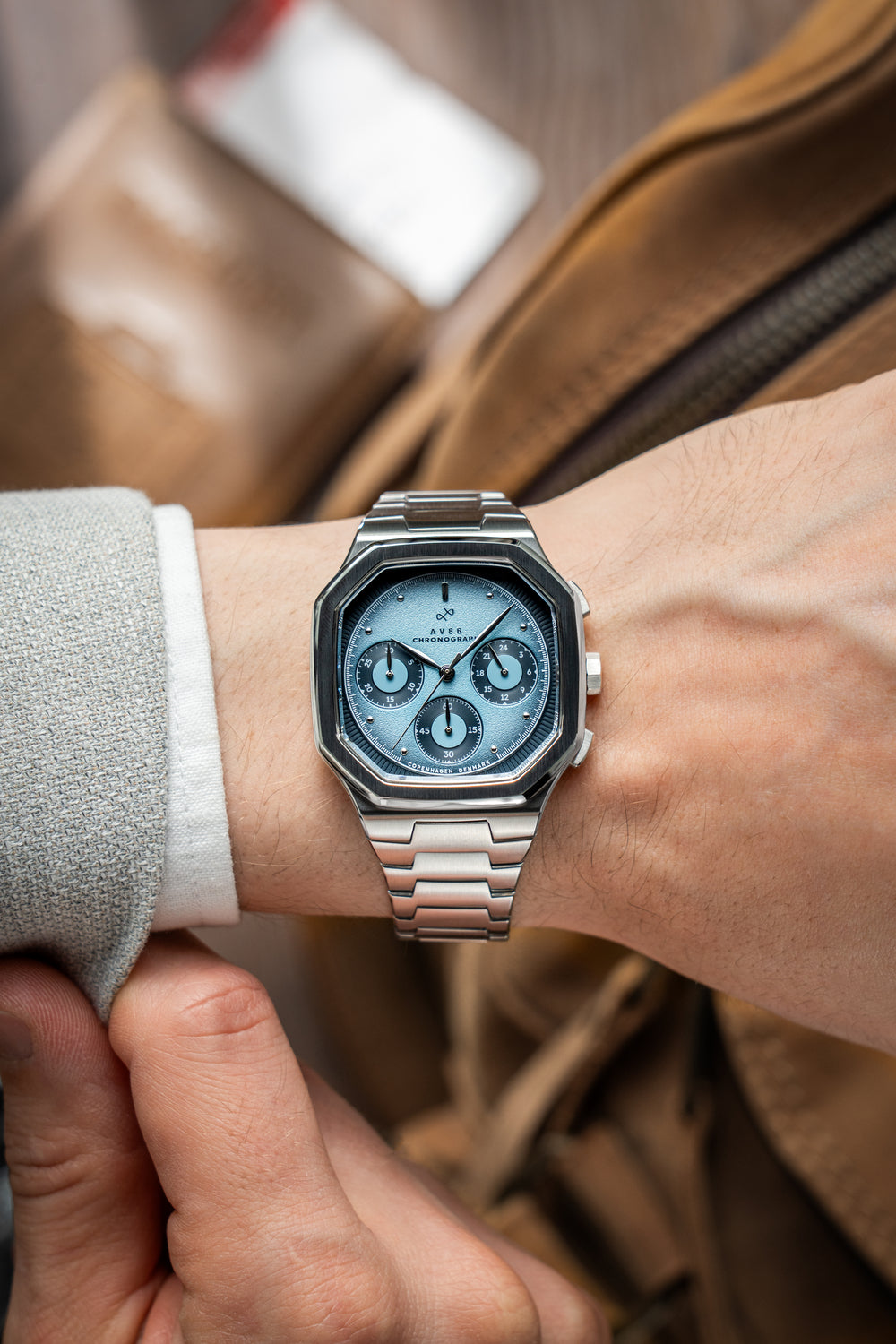 1904 Chronograph by AV86 with angular case, sapphire crystal, chronograph subdials, and polished metal bracelet strap