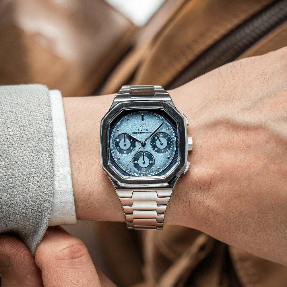 1904 Chronograph by AV86 luxury watch with angular case, sapphire crystal, chronograph subdials, and polished metal bracelet strap