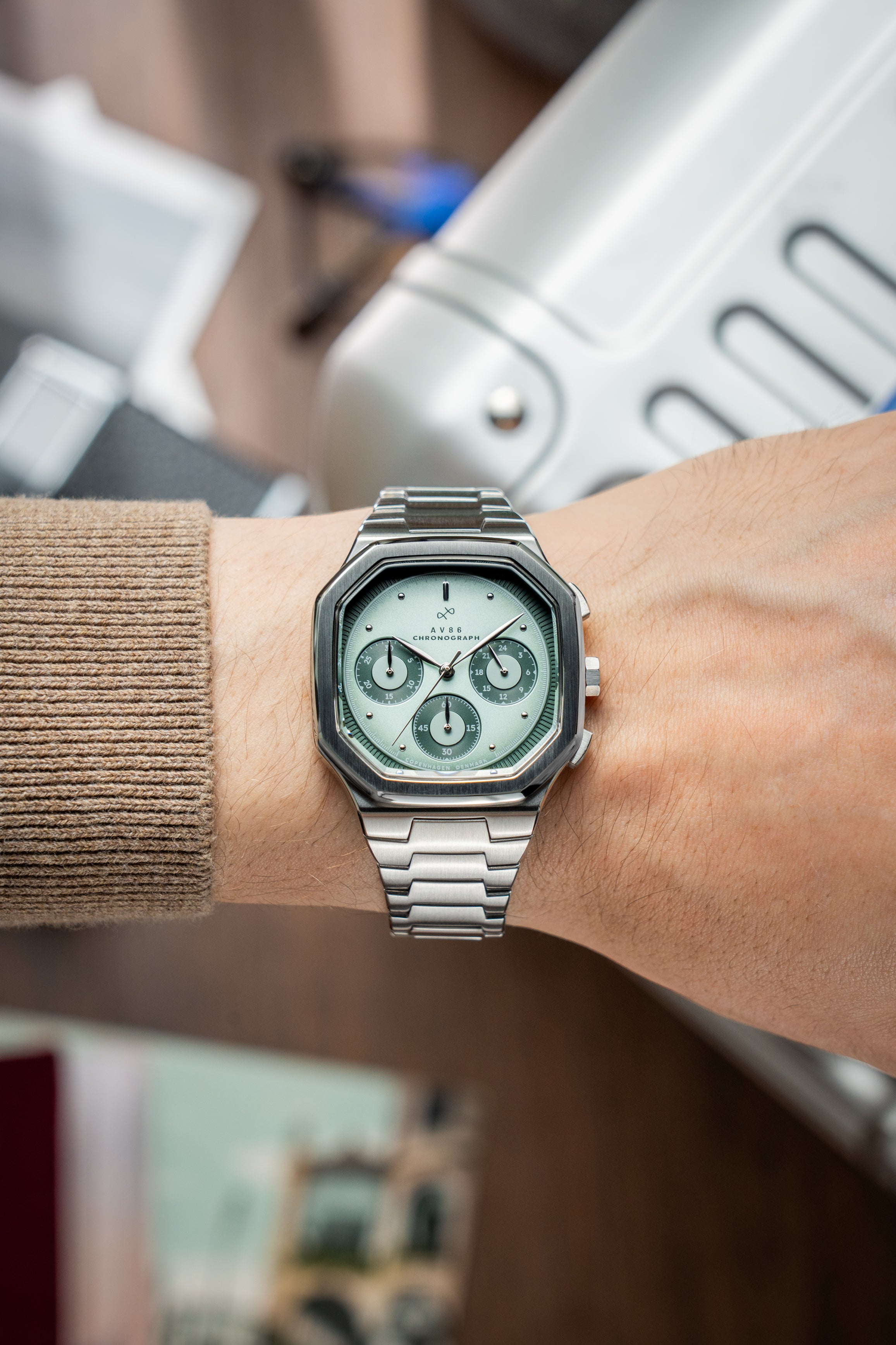 1904 Chronograph by AV86 with angular case, sapphire crystal, chronograph dial, and brushed metal bracelet strap