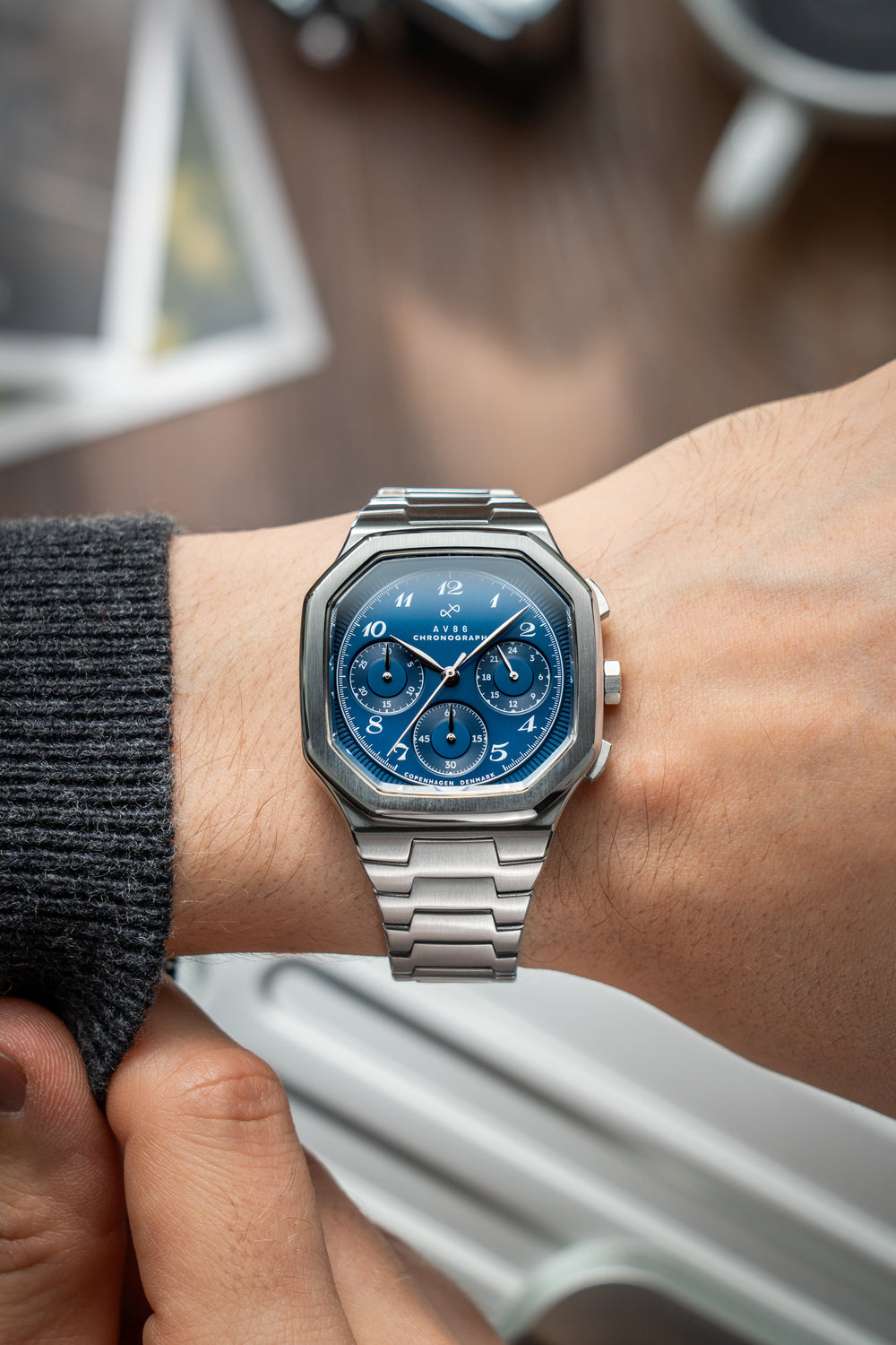 1904 Chronograph by AV86 with angular case, sapphire crystal, blue vintage-inspired dial, and polished steel bracelet strap