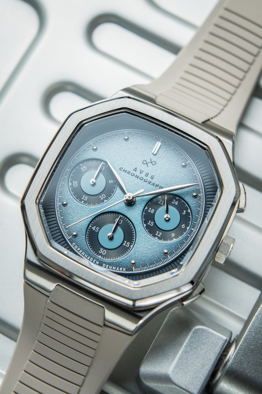 1904 Chronograph by AV86 with angular case, textured dial, sapphire crystal, chronograph subdials, and rubber strap