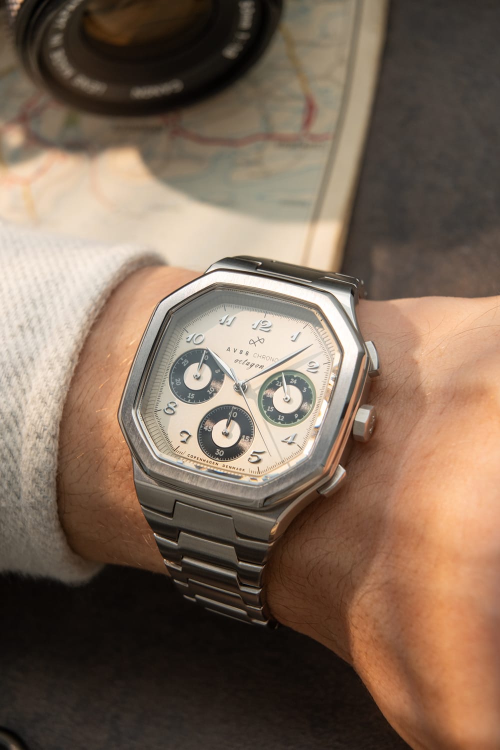Wristwear featuring the 1904 Chrono by AV86, a luxury chronograph with a hexagonal stainless steel case, sapphire crystal, and a linked metal bracelet in a refined, minimalist setting.
