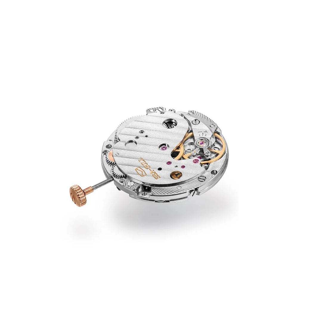 Mechanical watch movement by AV86 with visible gear train, ruby jewels, and rose gold crown winding stem detail.