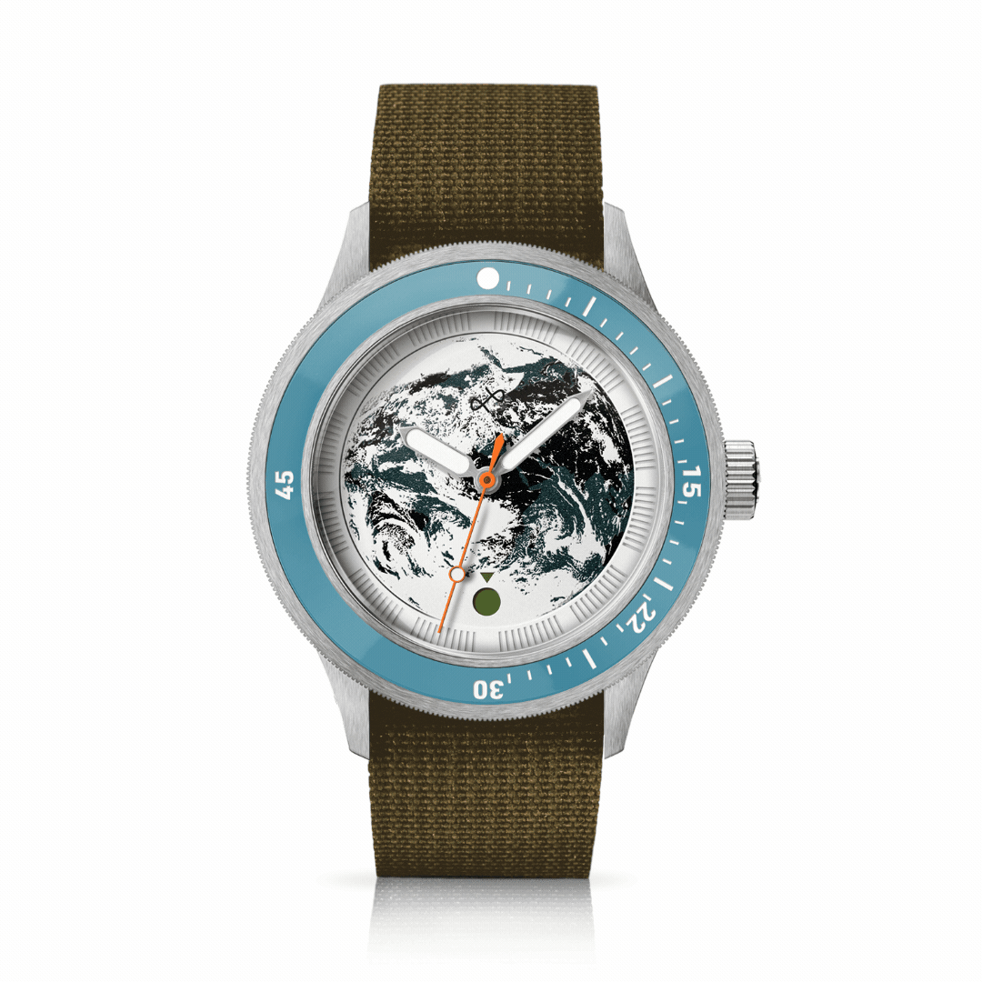 Diver watch with textured Earth dial, rotating blue bezel, and durable olive fabric strap reflecting Nordic minimalism by AV86.