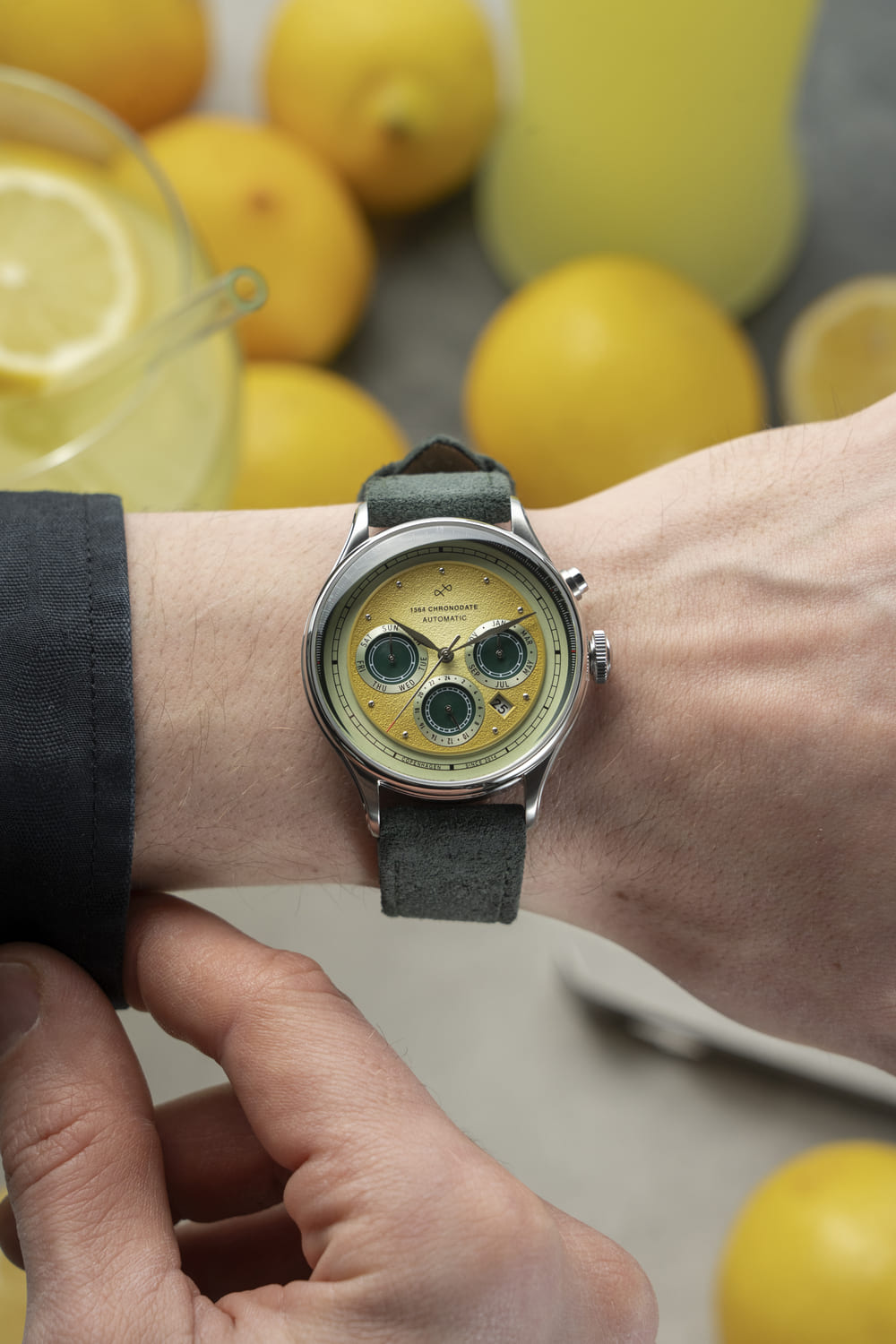 1564 Chronodate Automatic by AV86 vintage-inspired chronograph with sapphire crystal, textured dial, and suede leather strap on wrist