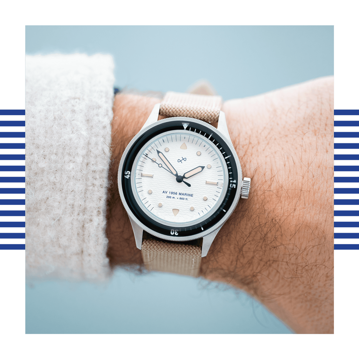AV86 vintage-inspired diver watch worn on the wrist with a textured fabric strap, rotating bezel, luminous markers and broad hands beside a knit sleeve