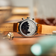 1844 Chronograph by AV86 showcasing engraved case back, polished steel, and genuine leather strap in a warm ambient setting