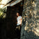Man in minimalist casual wear standing in rustic Mediterranean doorway, wearing 1954 Amalfi Mechanical, Gold / Midnight Blue by AV86