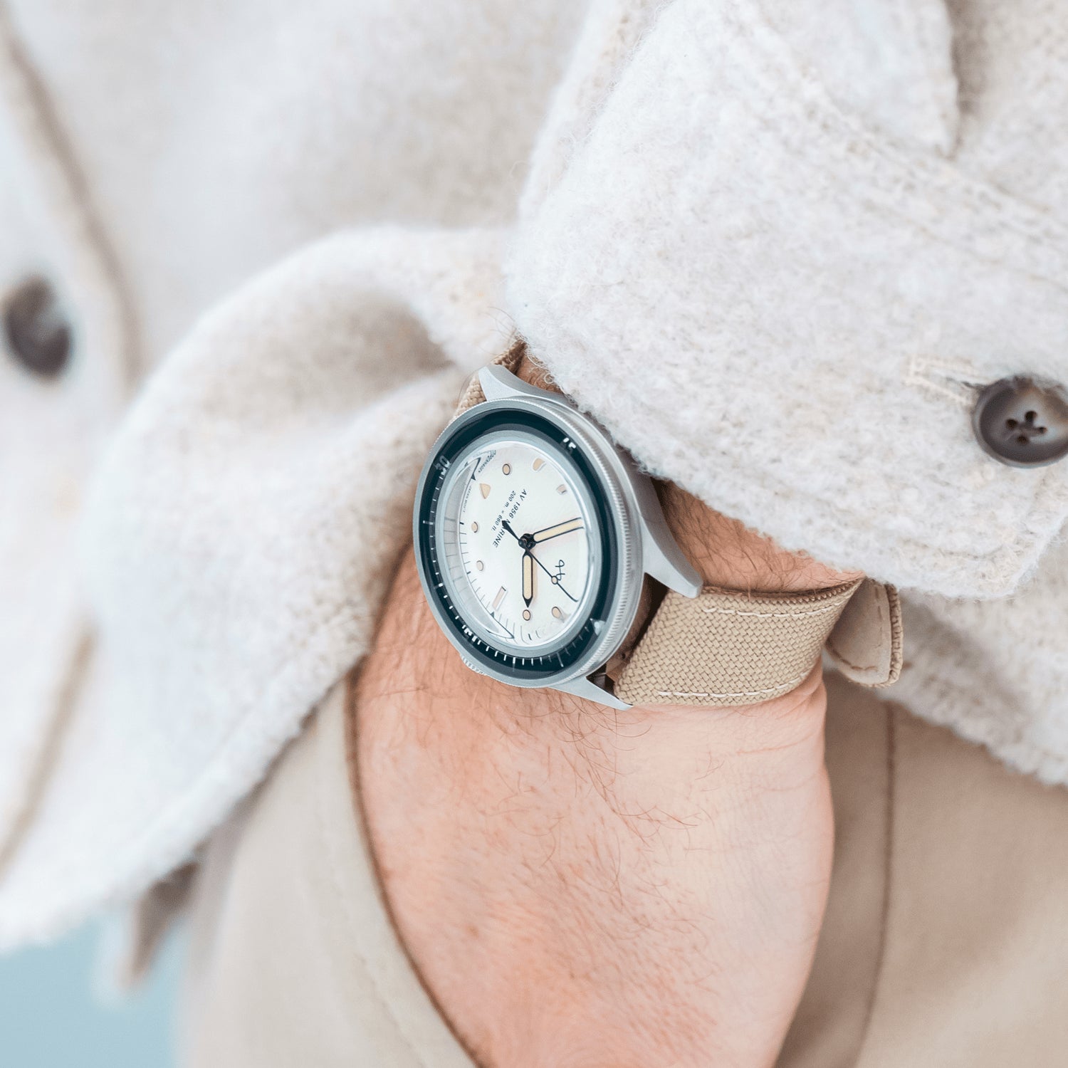 1956 Marine by AV86 vintage-inspired diver with acrylic bezel, luminous markers, and beige fabric strap on wrist