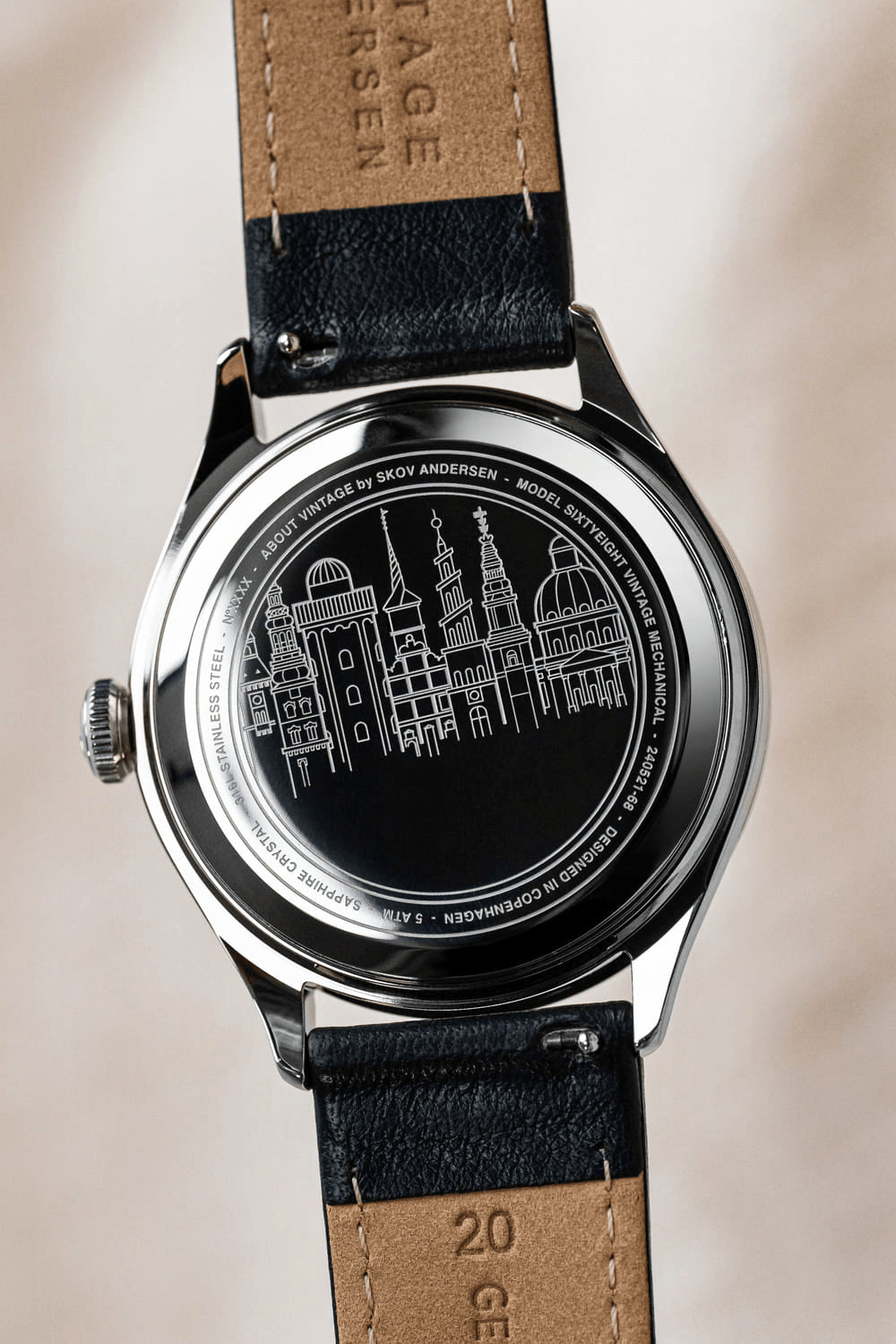 1968 Mechanical by AV86 with intricate cityscape engraving, stainless steel case back, sapphire crystal, and leather strap