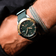 1970 Haagen GMT Automatic by AV86 with vintage-inspired dial, compass bezel, sapphire crystal, and textured fabric strap on wrist