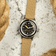1956 Marine by AV86 vintage-inspired diver with acrylic bezel, textured black dial, luminous markers, and beige fabric strap