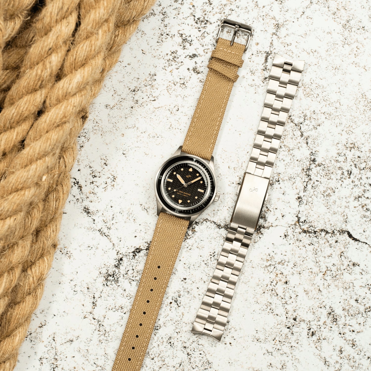 1956 Marine by AV86 vintage-inspired diver with acrylic filled bezel, large luminous markers, beige fabric strap, and metal bracelet option
