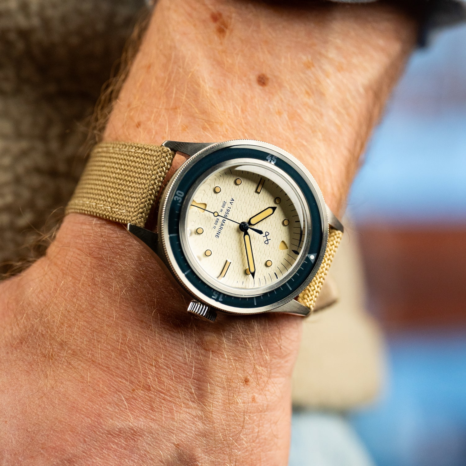 1956 Marine by AV86 vintage-inspired diver with acrylic bezel, luminous markers, textured dial, and woven fabric strap on wrist