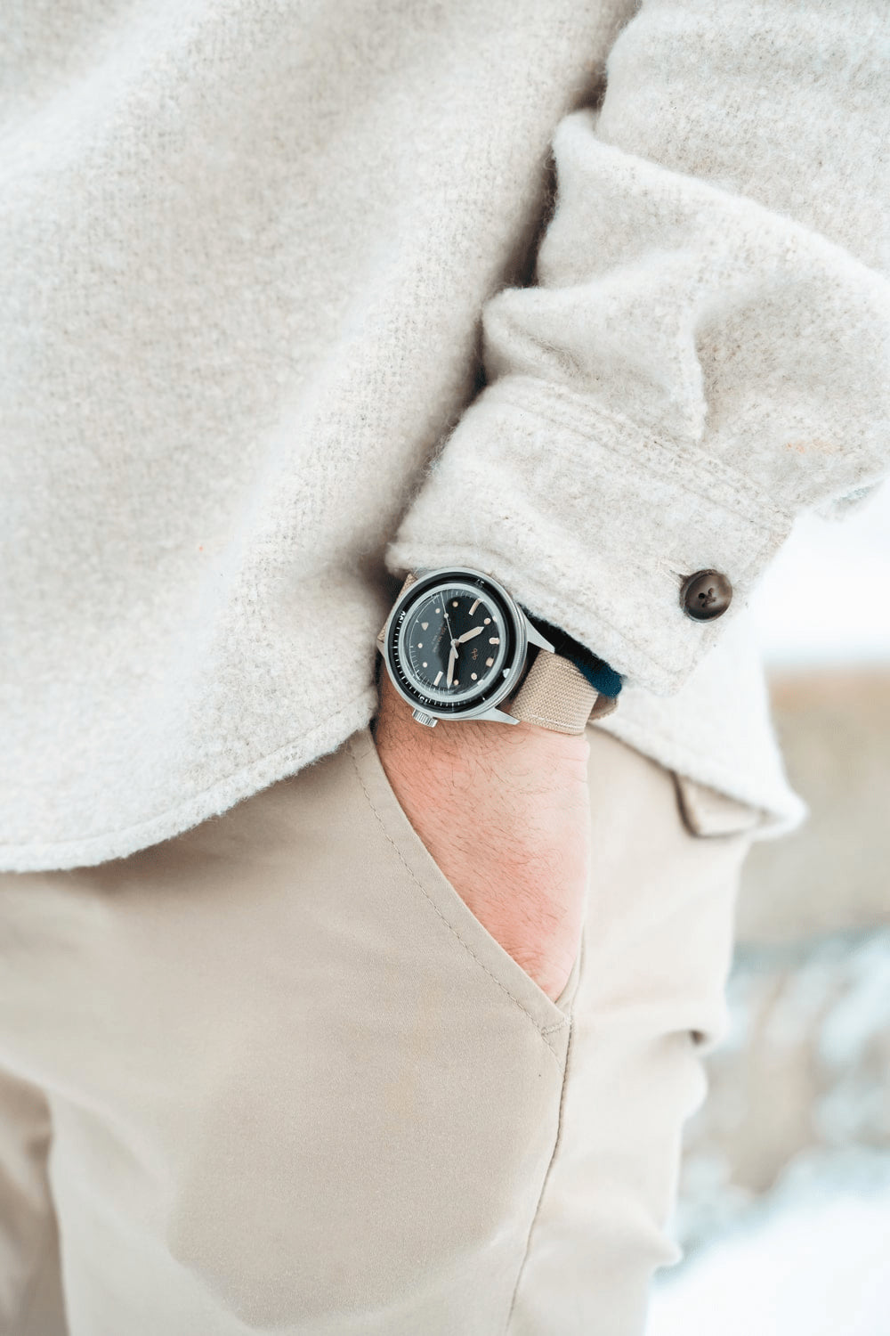 1956 Marine by AV86 vintage-inspired diver with acrylic bezel, luminous markers, and beige fabric strap in casual attire setting
