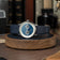 1968 Moonphase by AV86 luxury moonphase watch with sapphire crystal, vintage-inspired dial, and dark leather strap on wooden stand