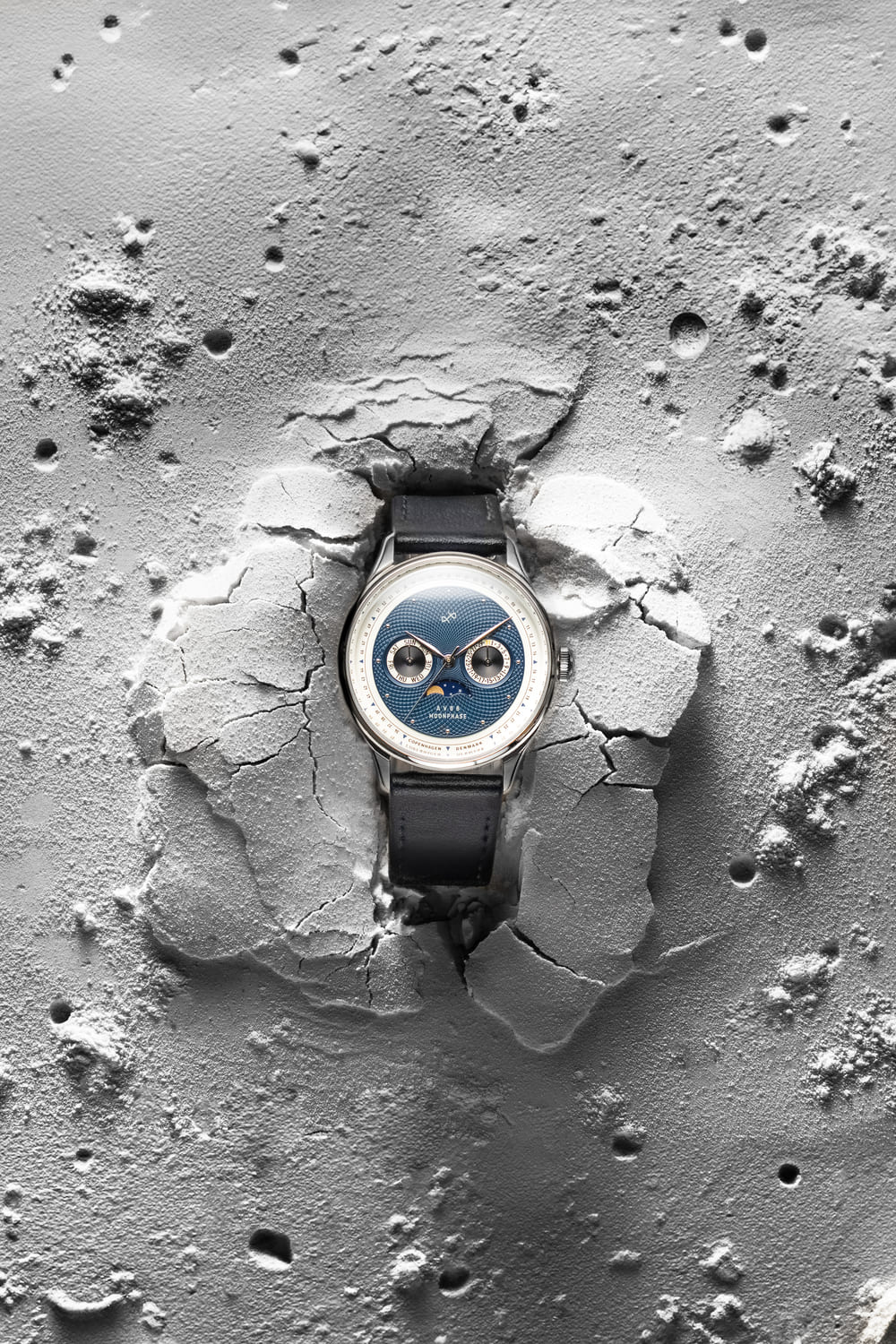 1968 Moonphase by AV86 luxury moonphase watch with sapphire crystal, textured dial, and black leather strap on lunar surface backdrop