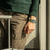 1904 Chronograph by AV86 with angular case, sapphire crystal, chronograph dial, and green fabric strap in casual travel setting