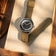 1956 Marine by AV86 vintage-inspired diver with sapphire crystal, compass bezel, and durable fabric strap on book surface