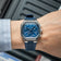 1904 Chronograph by AV86 with angular case, sapphire crystal, blue dial, three subdials, and blue rubber strap on wrist