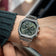 1904 Chronograph by AV86 with angular case, olive green dial, sapphire crystal, chronograph subdials, and steel link strap