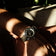 1956 Marine by AV86 vintage-inspired diver watch with compass bezel, domed sapphire crystal, and textured fabric strap on wrist