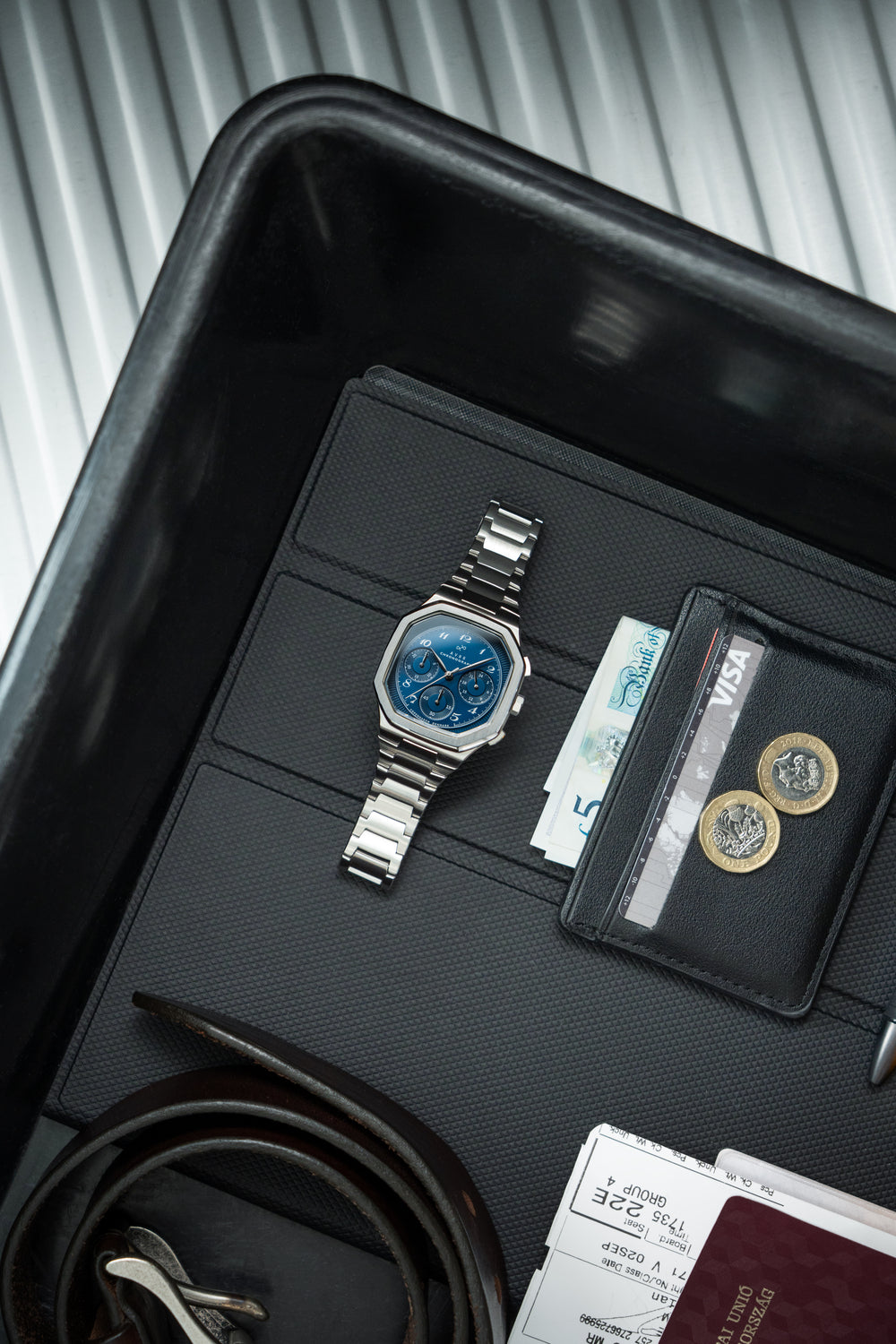 1904 Chronograph by AV86 with angular case, sapphire crystal, chronograph dial, and polished metal bracelet strap in a sleek tray setting