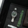 1904 Chronograph by AV86 with angular case, vintage-inspired dial, sapphire crystal, steel bracelet, and olive green rubber strap