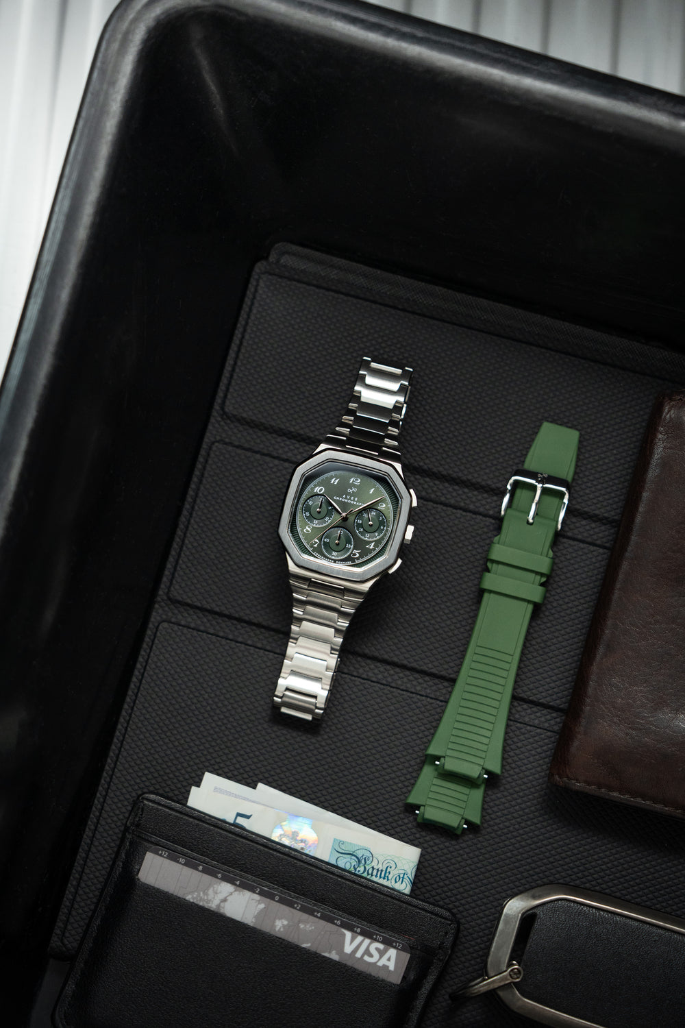 1904 Chronograph by AV86 with angular case, vintage-inspired dial, sapphire crystal, steel bracelet, and olive green rubber strap