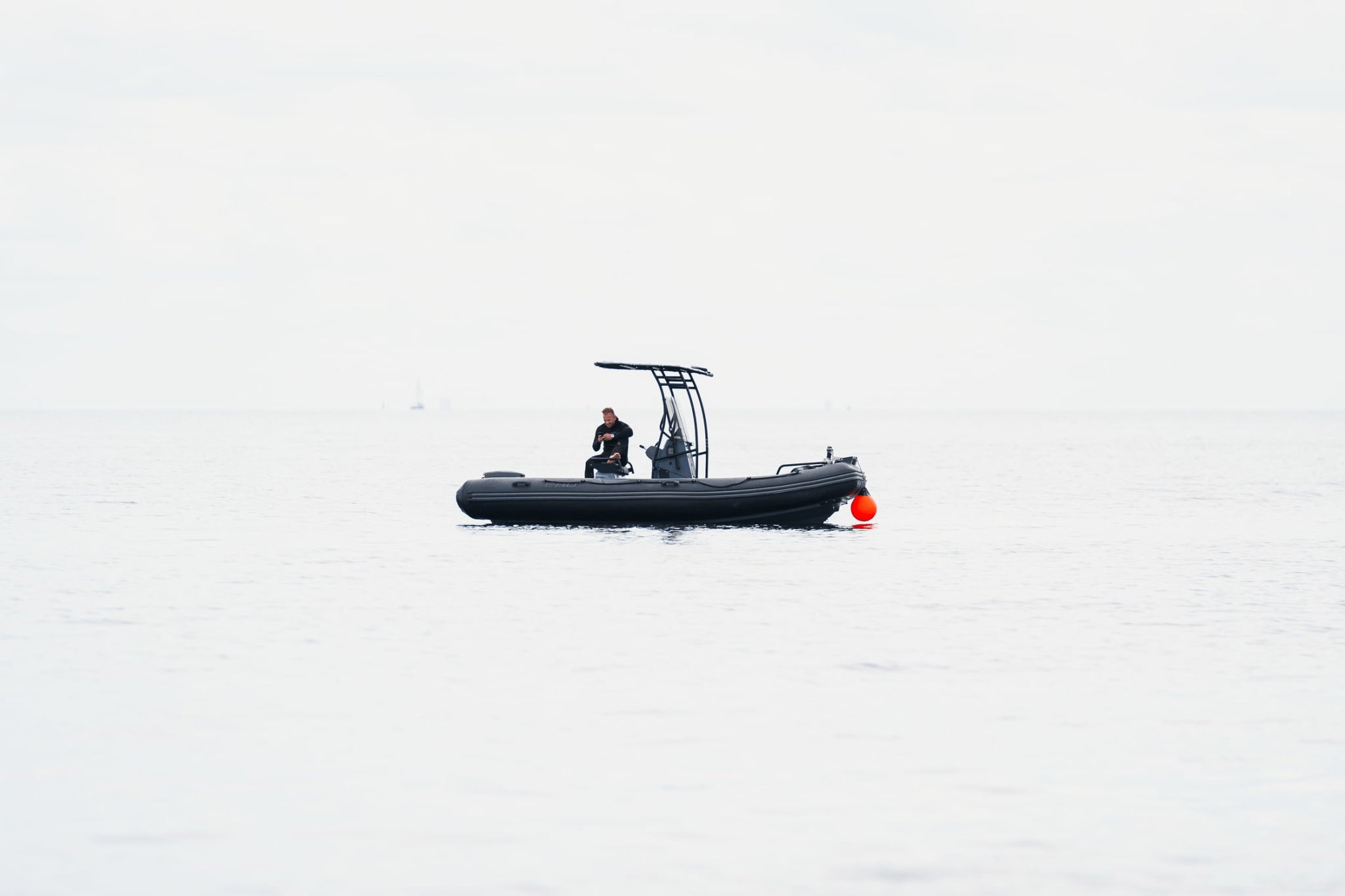 1956 Marine Automatic by AV86 minimalist nautical scene with diver aboard black RIB boat in calm open water