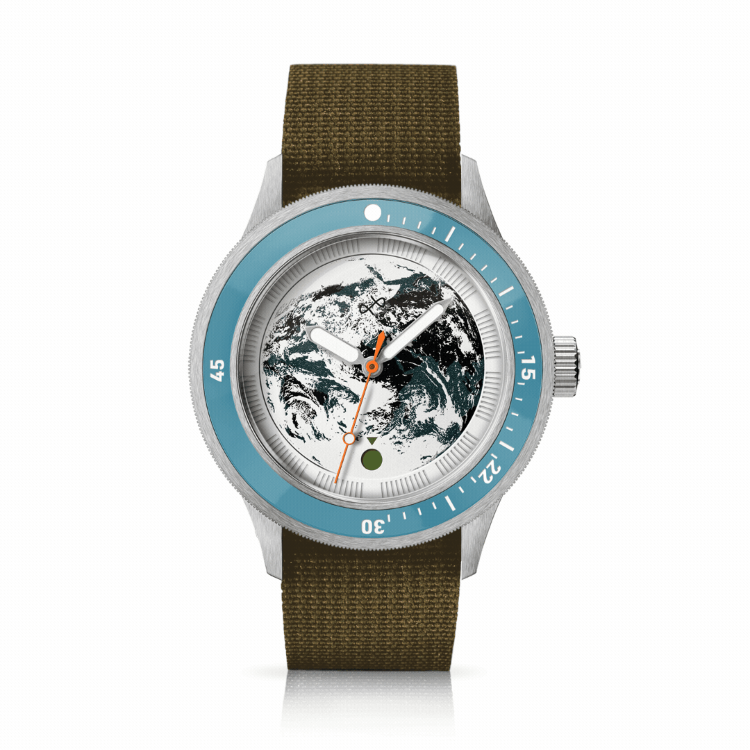 Diver watch with textured Earth dial, rotating blue bezel, and durable olive fabric strap reflecting Nordic minimalism by AV86.