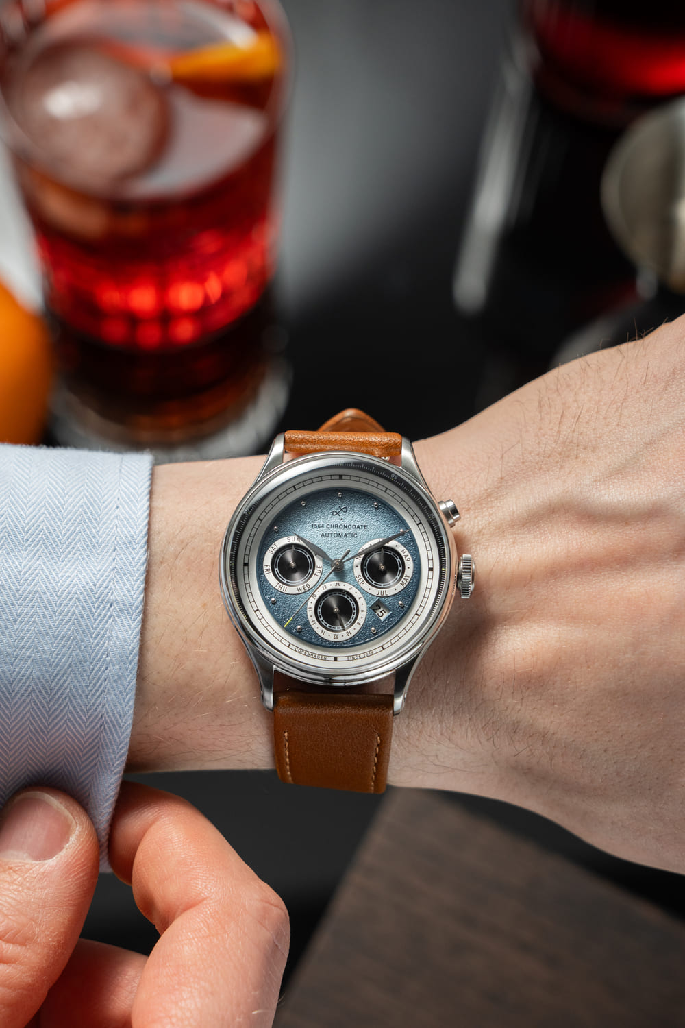 1564 Chronodate Automatic by AV86 vintage-inspired chronograph with sapphire crystal and brown leather strap on wrist