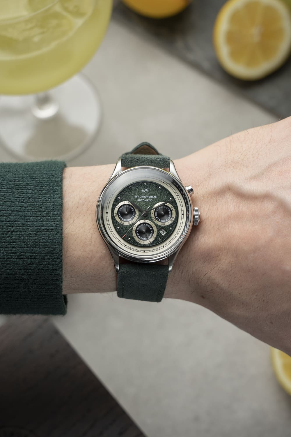 1564 Chronodate Automatic by AV86 luxury vintage-inspired chronograph with sapphire crystal and dark green leather strap on wrist