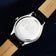 1968 Sixtyeight by AV86 showcasing stainless steel case back with engraved cityscape and genuine leather strap detailing